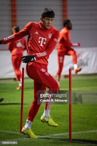 Kim Min-Jae of FC Bayern Muenchen jogs around the slalom poles during a training session at on December 16, 2023 in Munich, Germany.