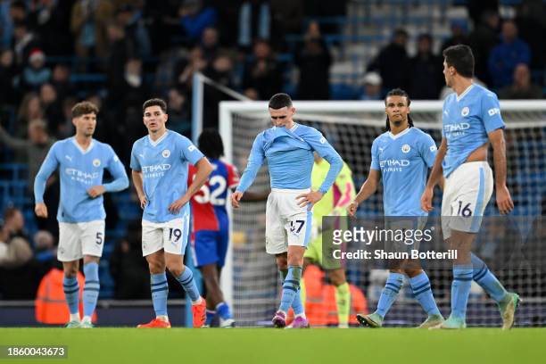 Phil Foden and teammates of Manchester City look dejected following the Premier League match between Manchester City and Crystal Palace at Etihad...