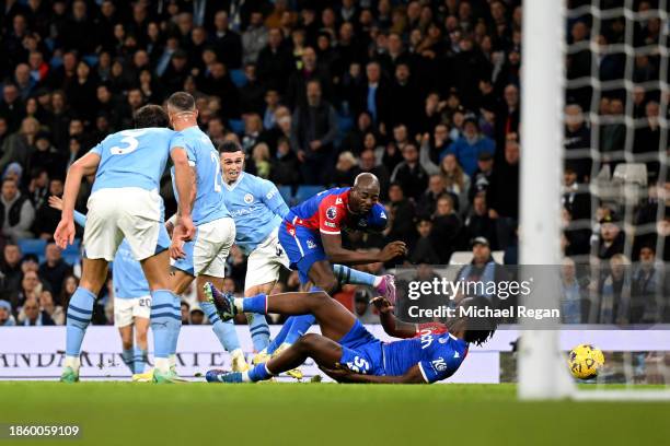 Phil Foden of Manchester City clashes with Jean-Philippe Mateta of Crystal Palace during the Premier League match between Manchester City and Crystal...