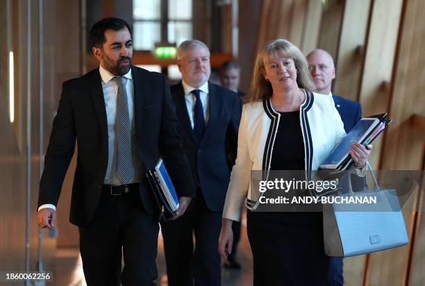 Scotland's First Minister Humza Yousaf and listens as Scotland's Deputy First Minister and Finance Minister, Shona Robison walk to the chamber where...