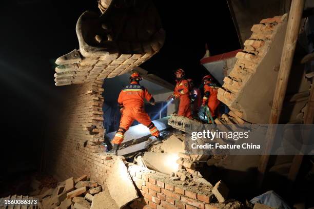 Rescuers work on the rubble of a house that collapsed in the earthquake in Kangdiao village of Jishishan county in northwest China's Gansu province...