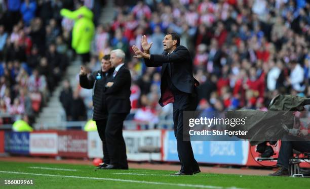 Newcastle manager Alan Pardew looks on as Sunderland manager Gus Poyet reacts during the Barclays Premier League match between Sunderland and...