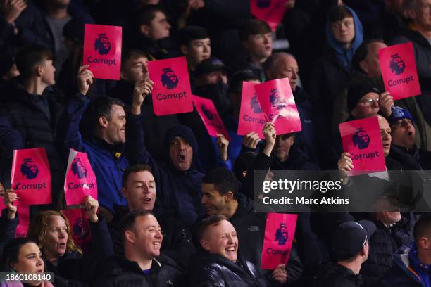 Everton FC fans hold up protest placards prior to the Premier League match between Burnley FC and Everton FC at Turf Moor on December 16, 2023 in...