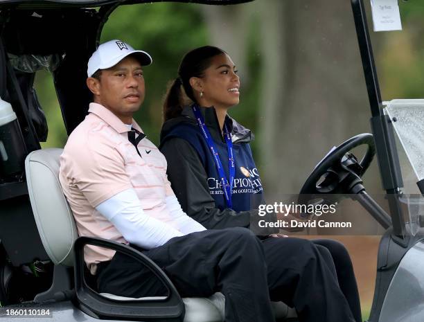 Tiger Woods of The United States is driven in his cart by his daughter Sam Woods on the ninth hole during the first round of the PNC Championship at...