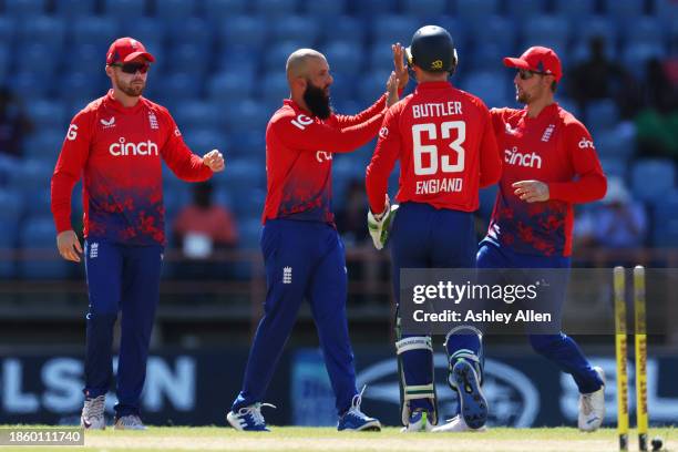 Moeen Ali of England celebrates with teammates after getting the wicket of Brandon King of West Indies during the 3rd T20 International match between...