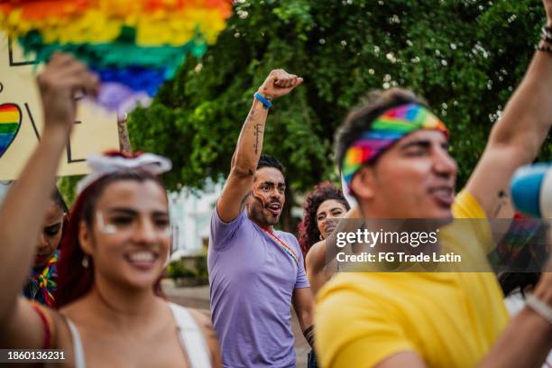 lgbtqia+ people marching during social movement protesting outdoors - pride march stock pictures, royalty-free photos & images