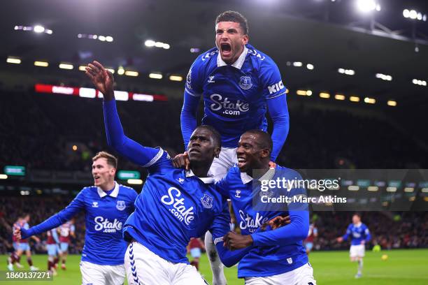 Amadou Onana of Everton celebrates with teammates Abdoulaye Doucoure and Ben Godfrey after scoring their team's first goal during the Premier League...