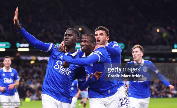 Amadou Onana of Everton celebrates with teammates Abdoulaye Doucoure and Ben Godfrey after scoring their team's first goal during the Premier League...