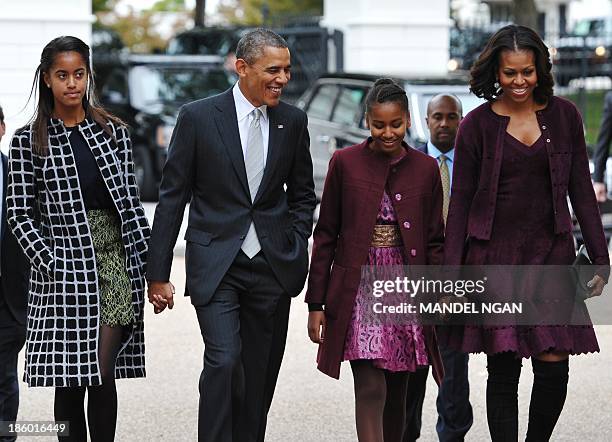 President Barack Obama and First Lady Michelle Obama walk with daughters Malia and Sasha across Lafayette Park to Saint John's Episcopal Chuch for...