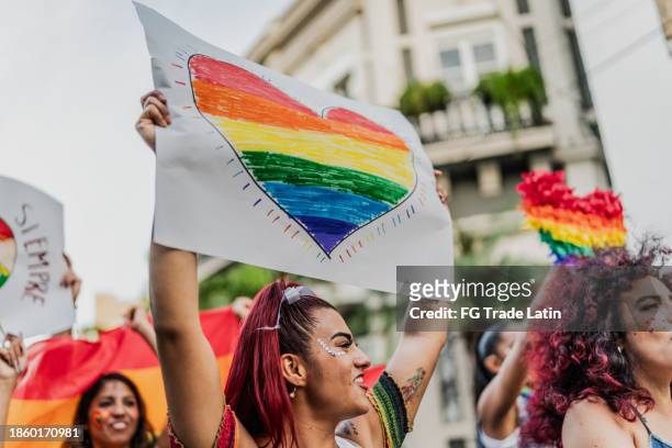 lgbtqia+ people marching during social movement protesting outdoors - lgbtqi stock pictures, royalty-free photos & images