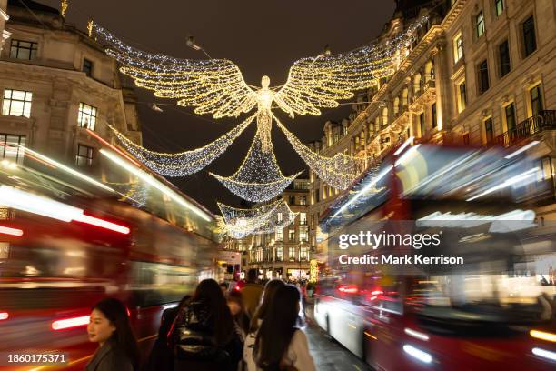 Shoppers are pictured on Regent Street a week before Christmas Day on 18th December 2023 in London, United Kingdom. Some retail analysts are...