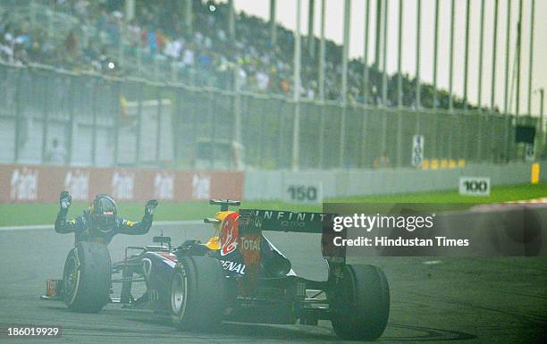 Sebastian Vettel of Germany and Red Bull Racing bows to the track after winning the Indian Formula One Grand Prix at The Buddh International circuit...