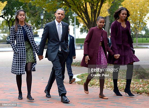 President Barack Obama walks with his wife Michelle Obama and two daughters Malia Obama and Sasha Obama through Lafayette Park to St John's Church to...