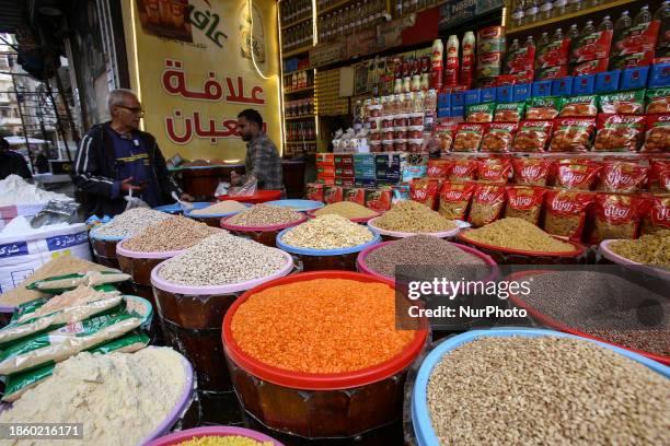 Vendor is serving customers at a fresh produce stall at the Sayyida Zeinab food market in the Sayyida Zeinab district of Cairo, Egypt, on December...