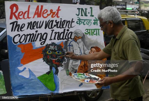 Teacher from a drawing academy is painting posters to raise awareness about the ongoing surge of the JN.1 Covid-19 variant, which is spreading in the...