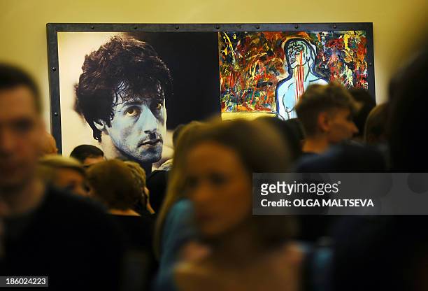 Visitors stand in front of the painting "Champion Due" by Sylvester Stallone during the art exhibition "Sylvester Stallone Painting From 1975 Until...