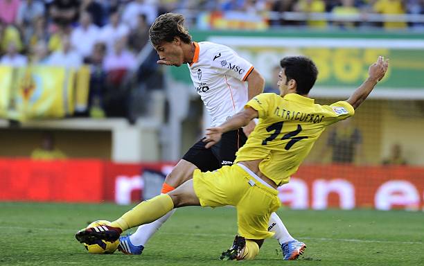 Valencia's midfielder Sergio Canales vies for the ball with Villarreal's midfielder Manu Trigueros during the Spanish league football match...