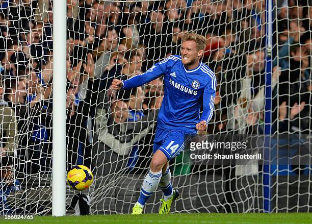 Andre Schurrle of Chelsea celebrates scoring their first goal during the Barclays Premier League match between Chelsea and Manchester City at...