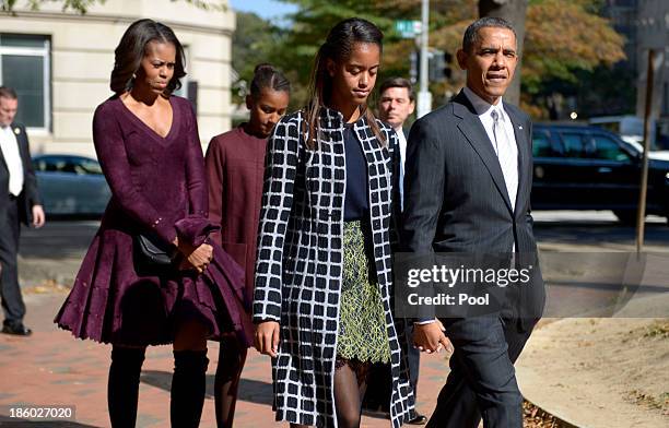 President Barack Obama walks with his wife Michelle Obama and two daughters Malia Obama and Sasha Obama from St. John's Church to the White House...