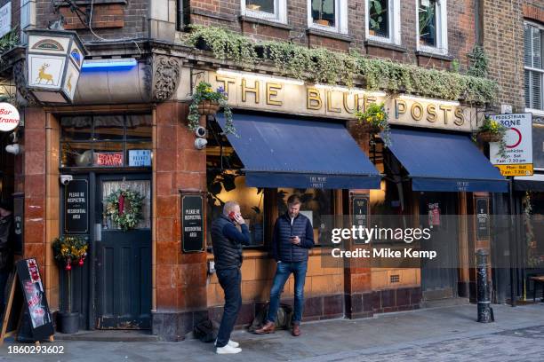 People outside the Blue Posts pub on the corner of Berwick Street and Broadwick Street in Soho on 6th December 2023 in London, United Kingdom. Part...