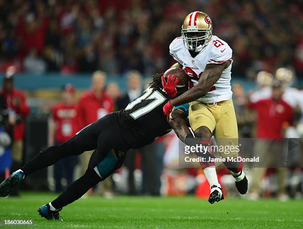 Frank Gore of the San Francisco 49ers goes through Johnathan Cyprien of the Jacksonville Jaguars to score a touchdown during the NFL International...
