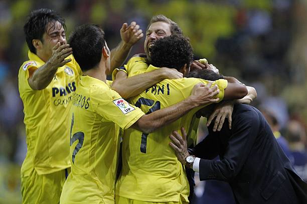 Villarreal's football players celebrate their four goal during the Spanish league football match Villarreal CF vs Valencia CF at the El Madrigal...