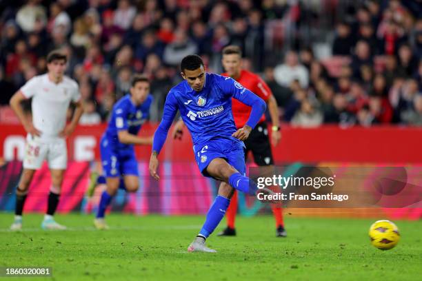 Mason Greenwood of Getafe CF scores their team's third goal from the penalty spot during the LaLiga EA Sports match between Sevilla FC and Getafe CF...