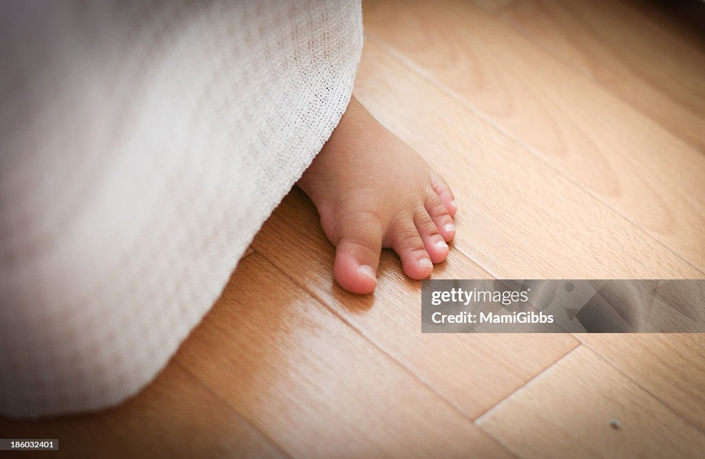 Foot of the baby from the curtain