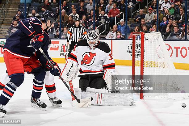 Goaltender Cory Schneider of the New Jersey Devils stops a shot from R.J. Umberger of the Columbus Blue Jackets on October 22, 2013 at Nationwide...