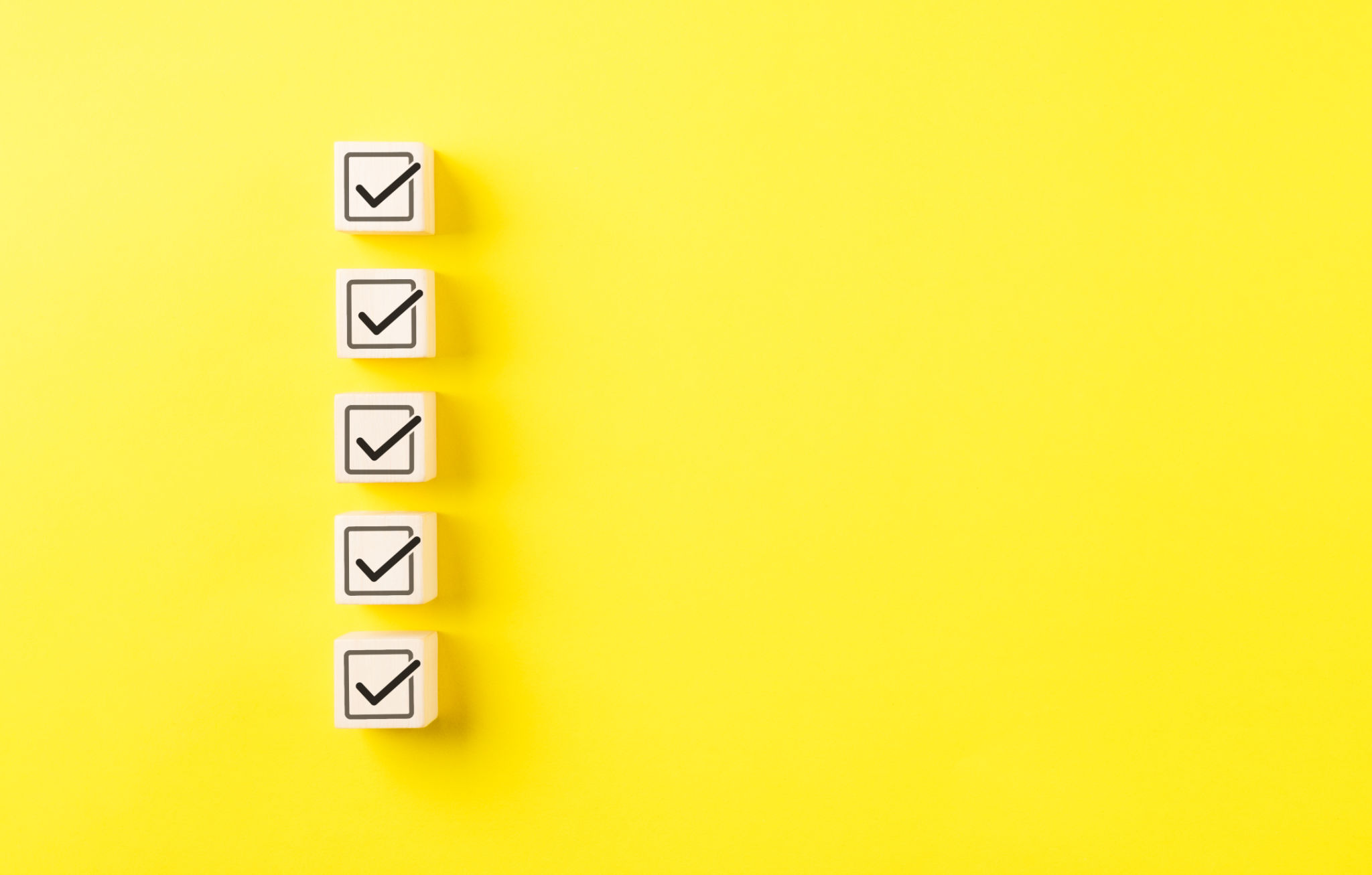 Checklist concept. Correct sign tick check mark on wooden block with copy space for the checklist on yellow background. Business survey questionnaire, Exam test process, filling digital form online, Checklist concept. Correct sign tick check mark on wooden block with copy space for the checklist on yellow background. Business survey questionnaire, Exam test process, filling digital form online,