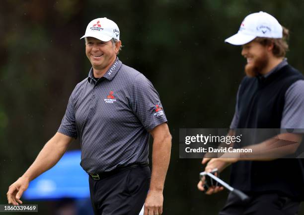 Retief Goosen of South Africa and his son Leo Goosen walk off the ninth green during the first round of the PNC Championship at The Ritz-Carlton Golf...