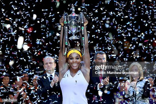 Serena Williams of the United States celebrates with the Billie Jean King Trophy after defeating Na Li of China during the final of the TEB BNP...