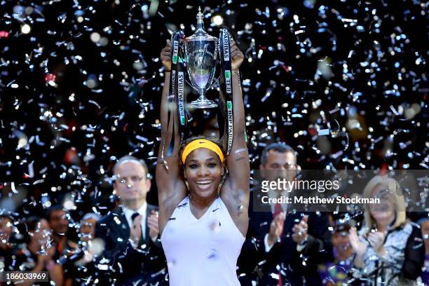 Serena Williams of the United States celebrates with the Billie Jean King Trophy after defeating Na Li of China during the final of the TEB BNP...