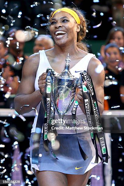 Serena Williams of the United States celebrates with the Billie Jean King Trophy after defeating Na Li of China during the final of the TEB BNP...