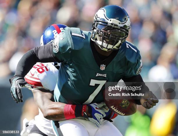 Quarterback Michael Vick of the Philadelphia Eagles fumbles as he is sacked by safety Antrel Rolle of the New York Giants during the first quarter of...