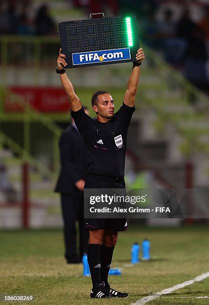 The fourth official shows the injury time on a board during the FIFA U-17 World Cup UAE 2013 Group E match between Argentina and Canada at Al Rashid...