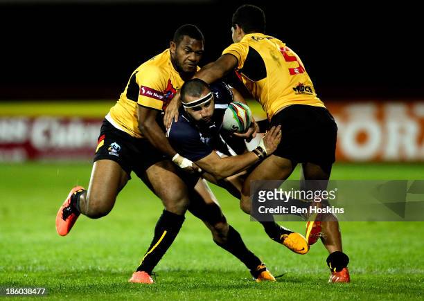 Vincent Duport of France is tackled by Isreal Eliab and Nene McDonald of Papua New Guinea during the Rugby World Cup Group B match between Papua New...