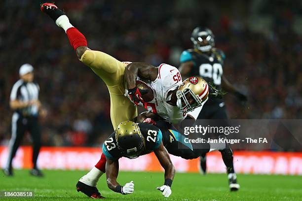 Vernon Davis of the San Francisco 49ers in tackled by Alan Ball of the Jacksonville Jaguars during the NFL International Series game between San...