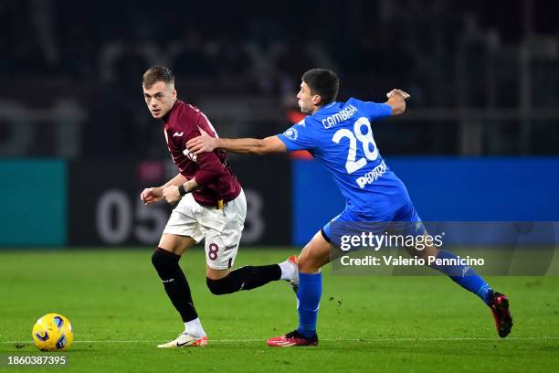 Ivan Ilic of Torino FC runs with the ball whilst under pressure from Nicolo Cambiaghi of Empoli FC during the Serie A TIM match between Torino FC and...