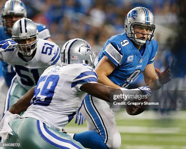 Matthew Stafford of the Detroit Lions tries to outrun the tackle of Ernie Sims of the Dallas Cowboys during the second quarter at Ford Field on...