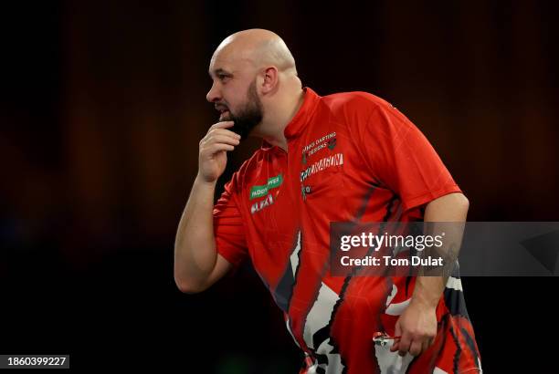 Jamie Hughes of England reacts in his First Round match against David Cameron of Canada on Day Two of 2023/24 Paddy Power World Darts Championship at...