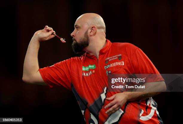 Jamie Hughes of England throws in his First Round match against David Cameron of Canada on Day Two of 2023/24 Paddy Power World Darts Championship at...