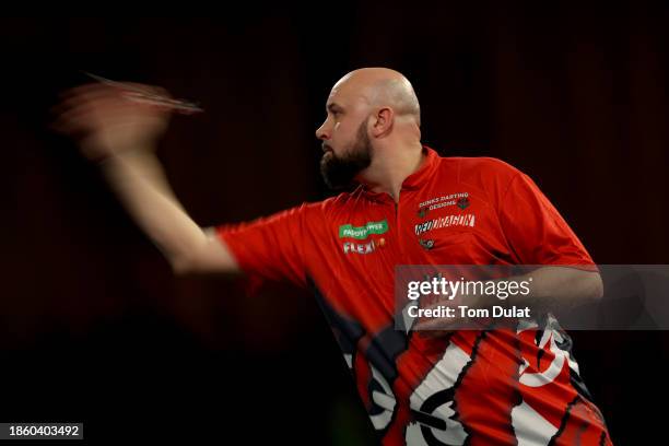 Jamie Hughes of England throws in his First Round match against David Cameron of Canada on Day Two of 2023/24 Paddy Power World Darts Championship at...