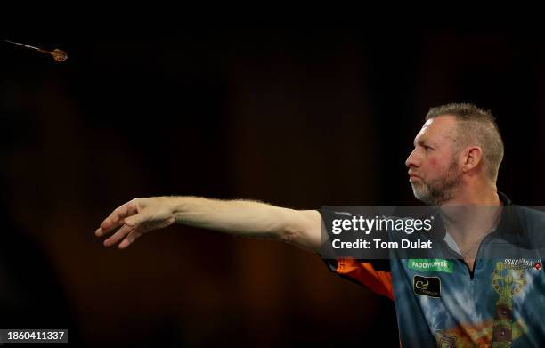 David Cameron of Canada throws in his First Round match against Jamie Hughes of England on Day Two of 2023/24 Paddy Power World Darts Championship at...