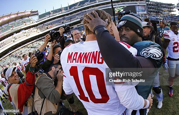 Quarterbacks Eli Manning of the New York Giants and Michael Vick of the Philadelphia Eagles hug after g a game at Lincoln Financial Field on October...