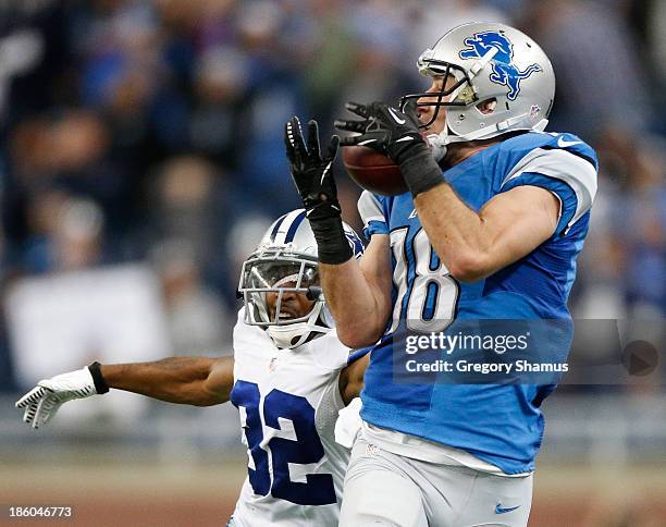 Kris Durham of the Detroit Lions catches a fourth quarter pass in front of Orlando Scandrick of the Dallas Cowboys at Ford Field on October 27, 2013...