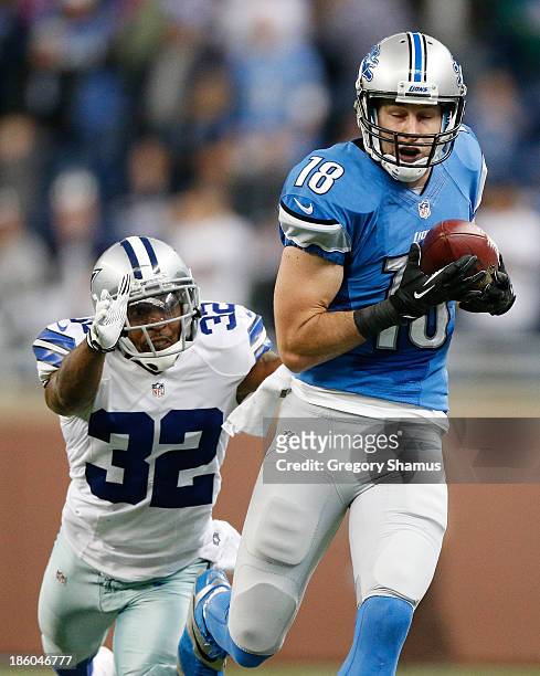 Kris Durham of the Detroit Lions catches a fourth quarter pass in front of Orlando Scandrick of the Dallas Cowboys at Ford Field on October 27, 2013...