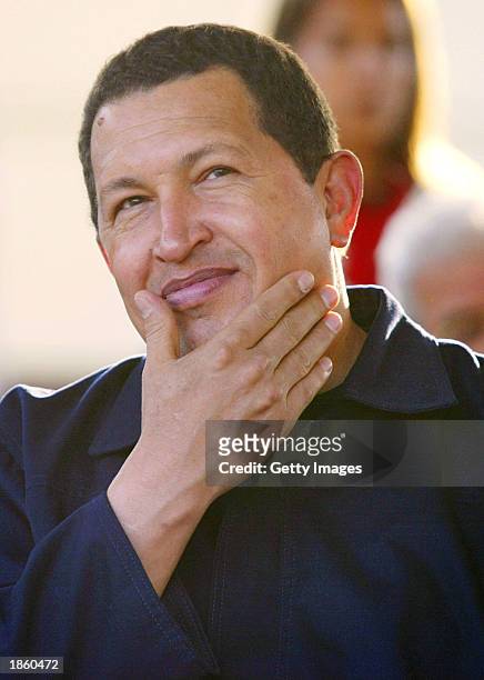 Venezuelan President Hugo Chavez smiles during a ceremony handing out land titles to low income households March 20, 2003 in Caracas, Venezuela....