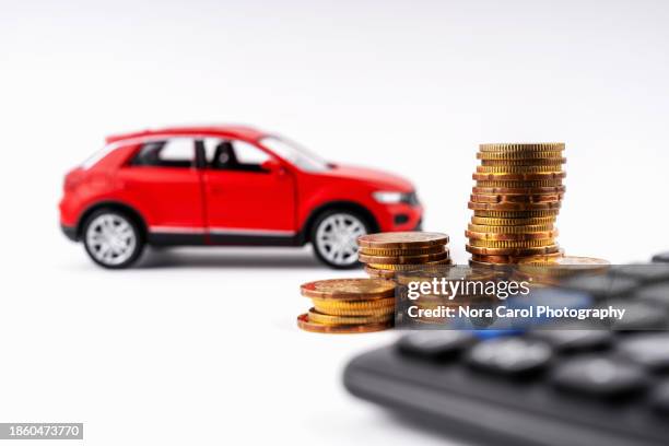 red car, calculator and stack of coins - auto-loan-bank stock pictures, royalty-free photos & images