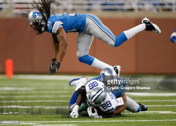 Dez Bryant of the Dallas Cowboys is tackled after a third quarter catch by Glover Quin and Rashean Mathis of the Detroit Lions at Ford Field on...